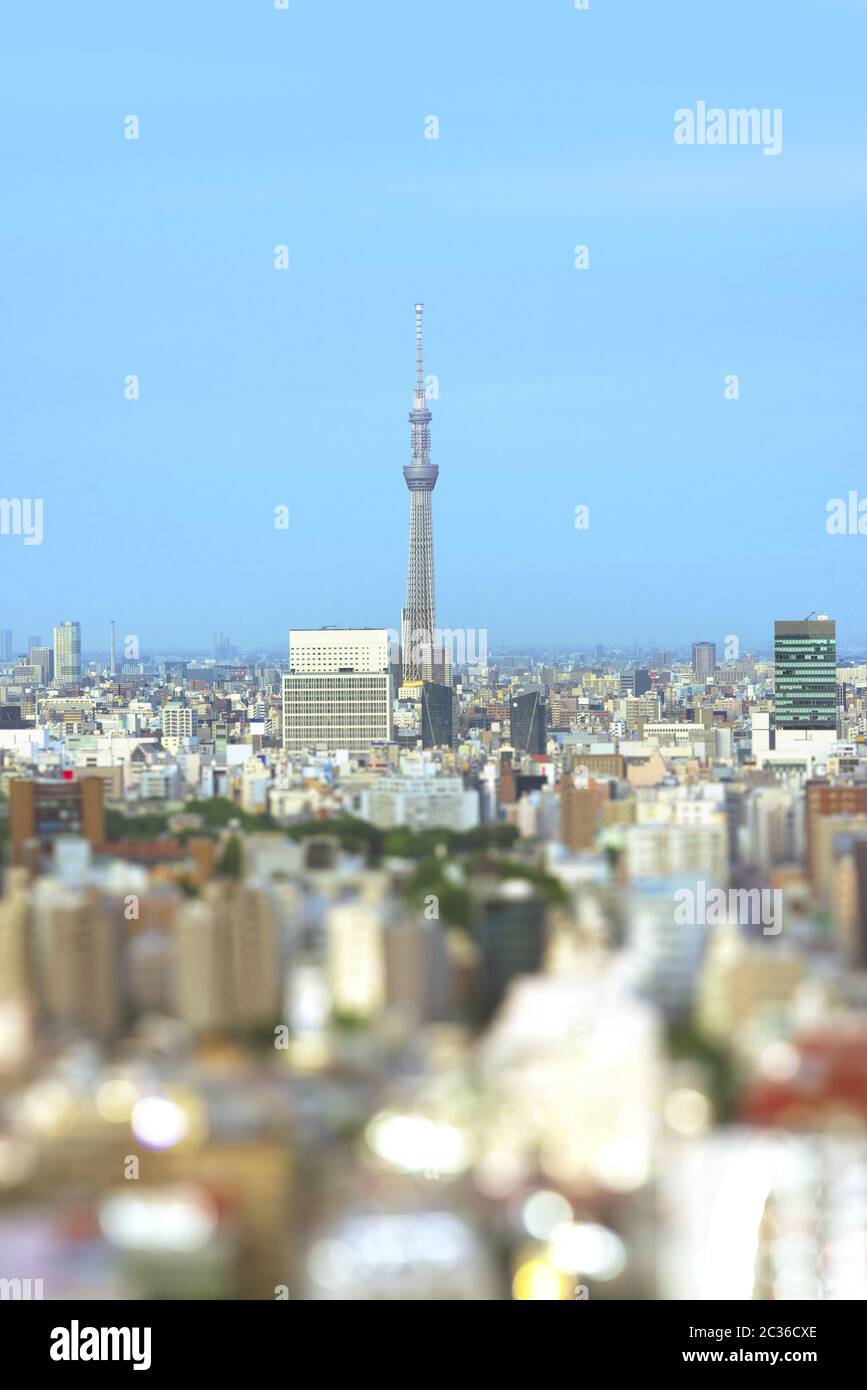 Aerial view in tilt-shift of the city of Tokyo with the skytree tower in the center and bokeh around Stock Photo
