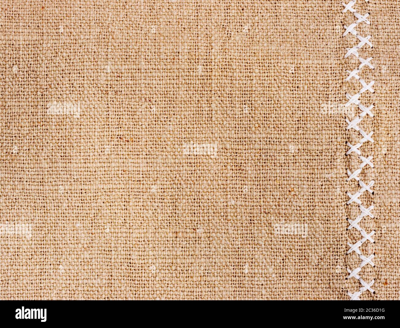 Natural cotton fabric with cross stitch close up as background texture Stock Photo