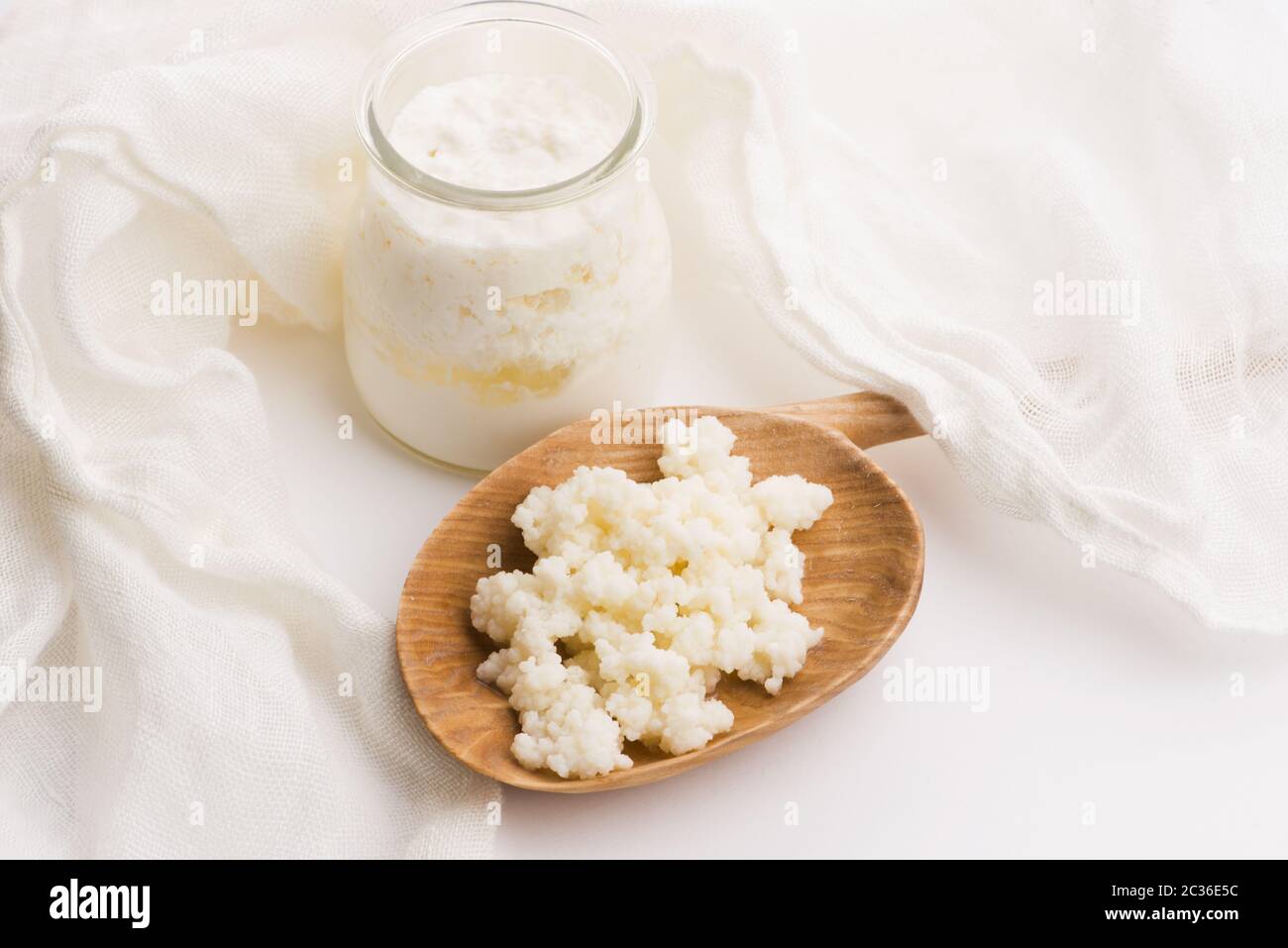 Milk kefir grains in spoon. Yeast bacterial fermentation starter Stock