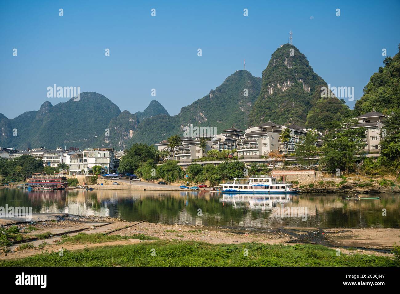 Yangshuo, China - August 2019 : Riverside shore of the Li riverbank above boat landing and ferry crossing Stock Photo