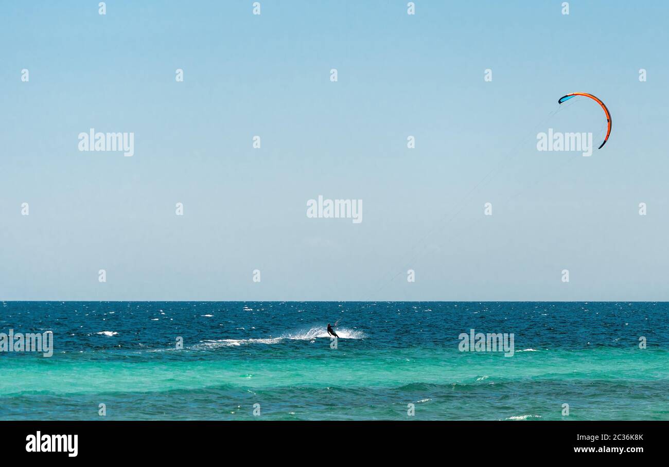 Extreme water sport - kiteserfing at sea on hot summer sunny day Copy space. The concept of an active and healthy life in harmony with nature Stock Photo