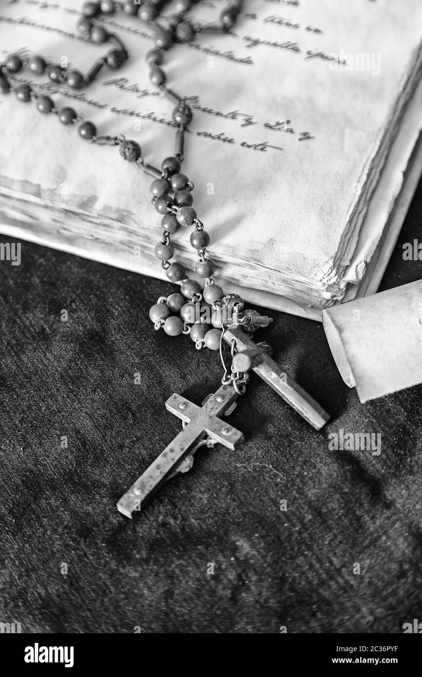 Antique Book with Cross, detail of an old book and a crucifix religious inquisition scene Stock Photo