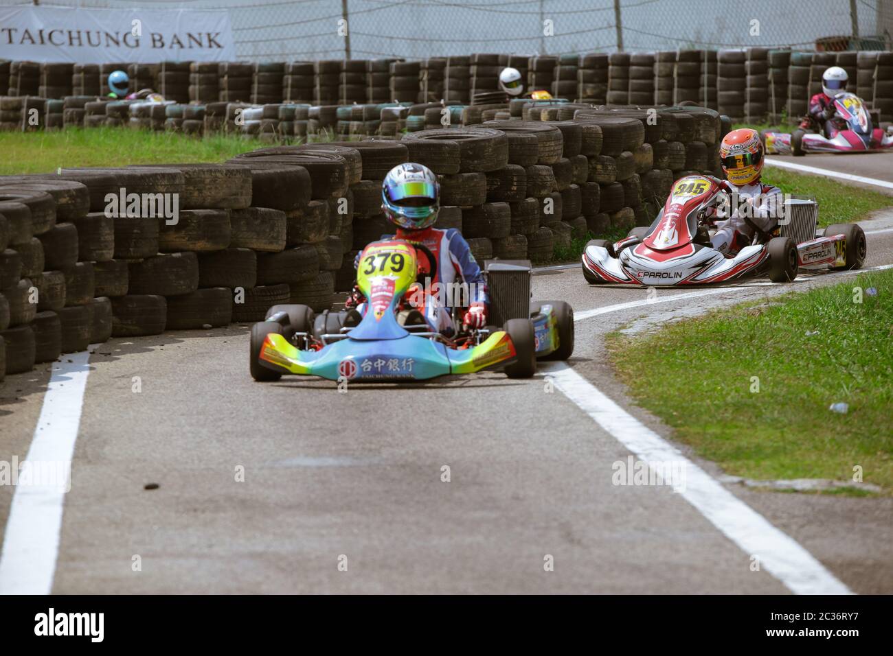 Kart racers zig-zaging into the pit stop zone after the race finish. Stock Photo