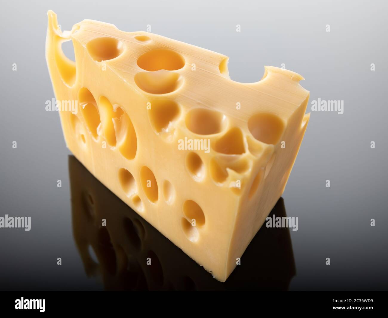 Swiss cheese with big holes isolated on dark background Stock Photo Alamy