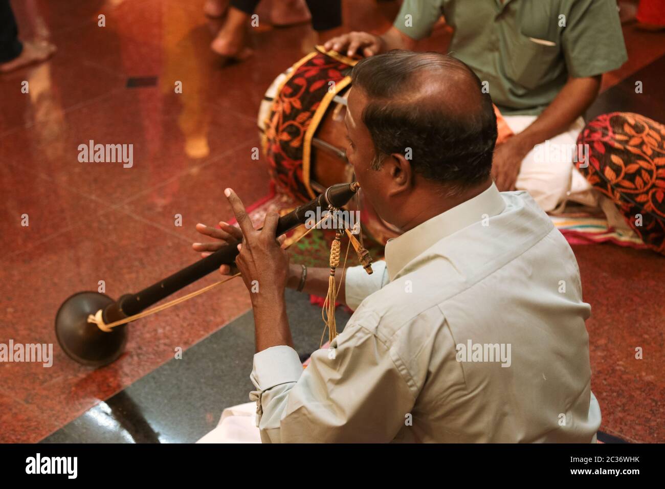 Temple musicians playing melody using shehnai and drum during Thaipusam