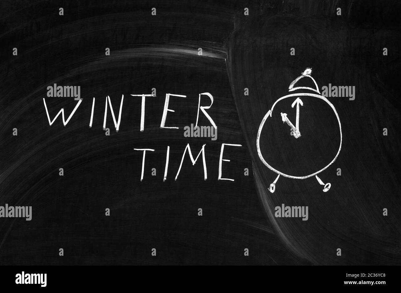 winter time handwritten on a chalkboard with chalk Stock Photo
