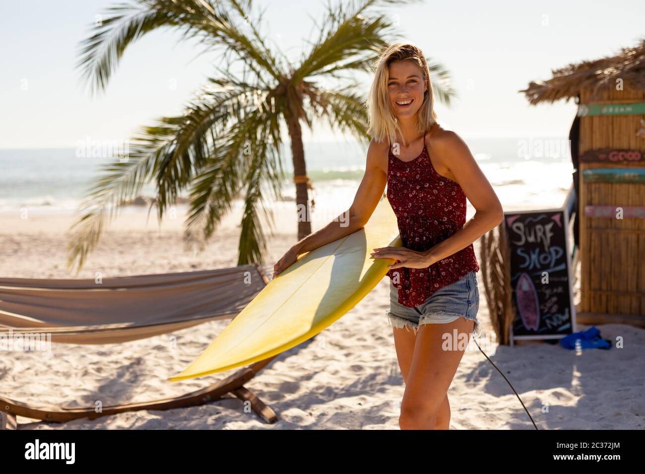 Female holding surfing board hi-res stock photography and images - Alamy