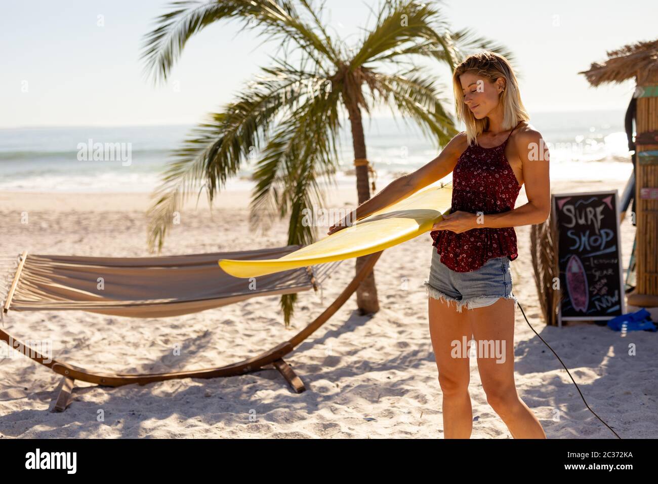 Woman standing on sea surf hi-res stock photography and images - Alamy