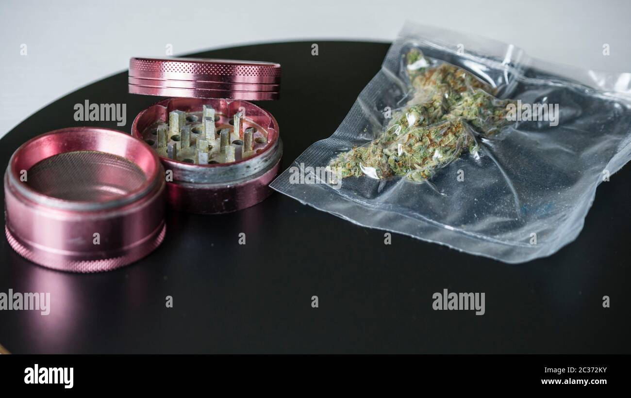 Closeup of medical marijuana buds in vacuum seal bags and grinder