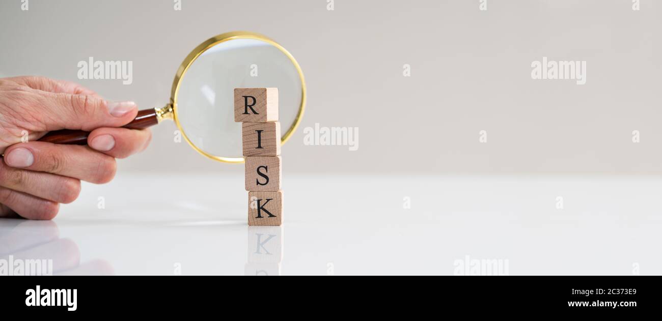 Monitoring High Risk Word Blocks Using Magnifying Glass Stock Photo