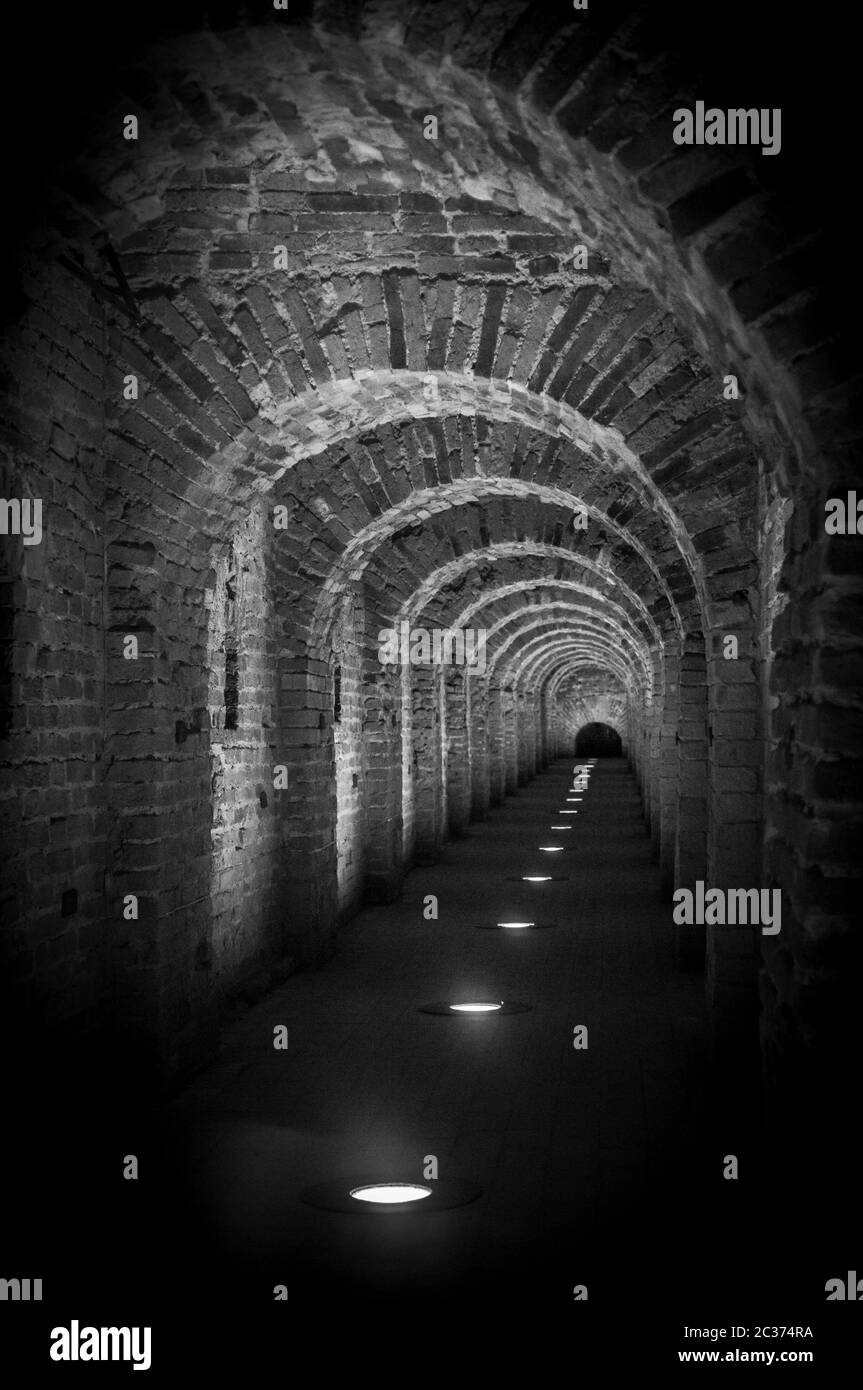 Brick tunnel archway made of red bricks as a passage between the two ...