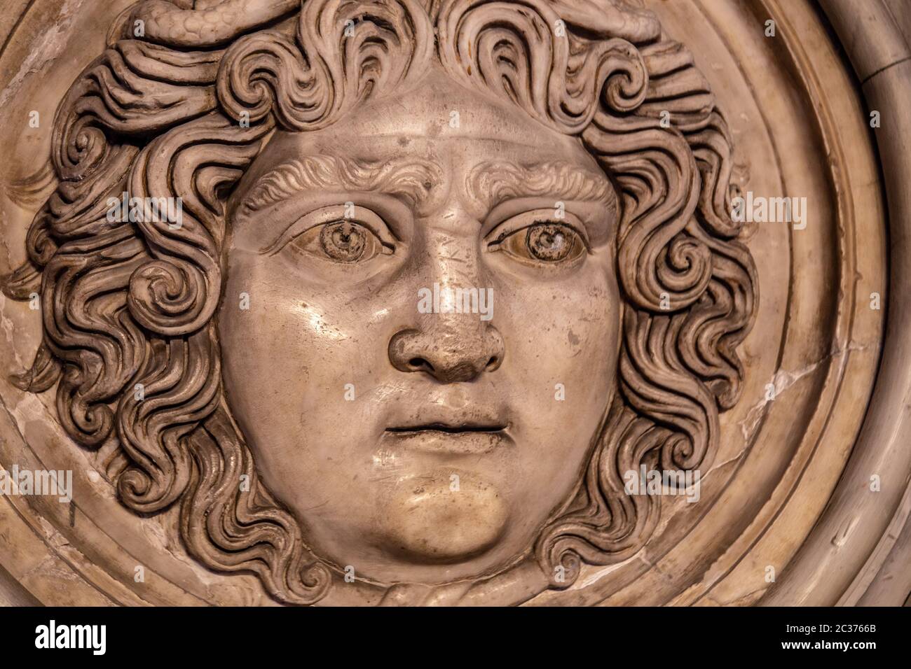 Medusa face sculpture. Head portrait of MedusaIn Greek mythology Medusa was a monster, a Gorgon, a winged human female with a hi Stock Photo