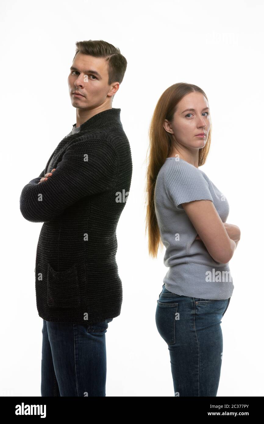 The couple got into a fight and standing with their backs to each other in the frame Stock Photo