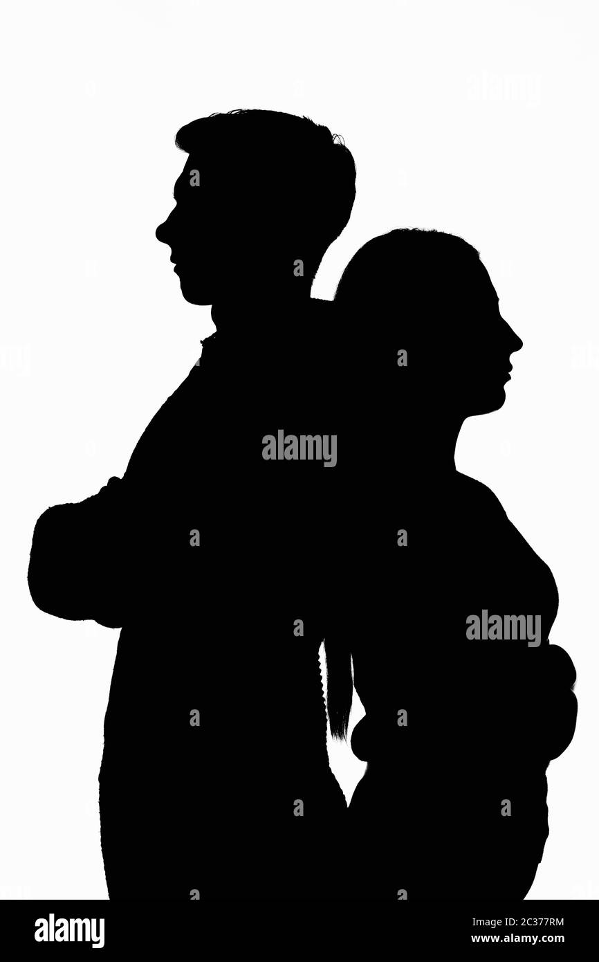 Dark silhouettes of a young couple on a white background Stock Photo