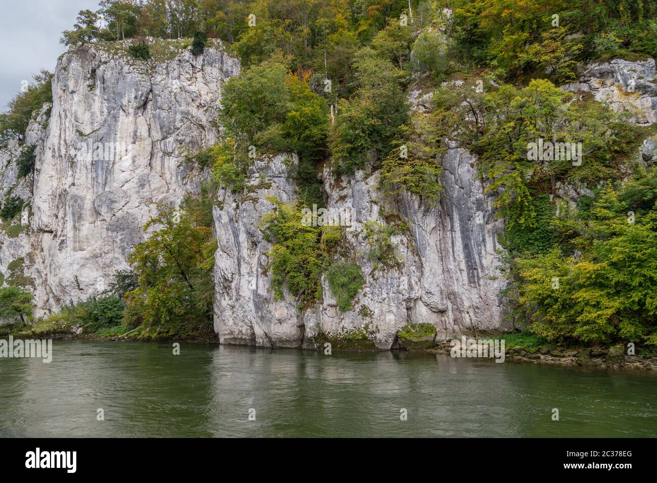 Danube river at Danube breakthrough near Kelheim, Bavaria, Germany in autumn with limestone rock formations and plants with colorful leaves Stock Photo