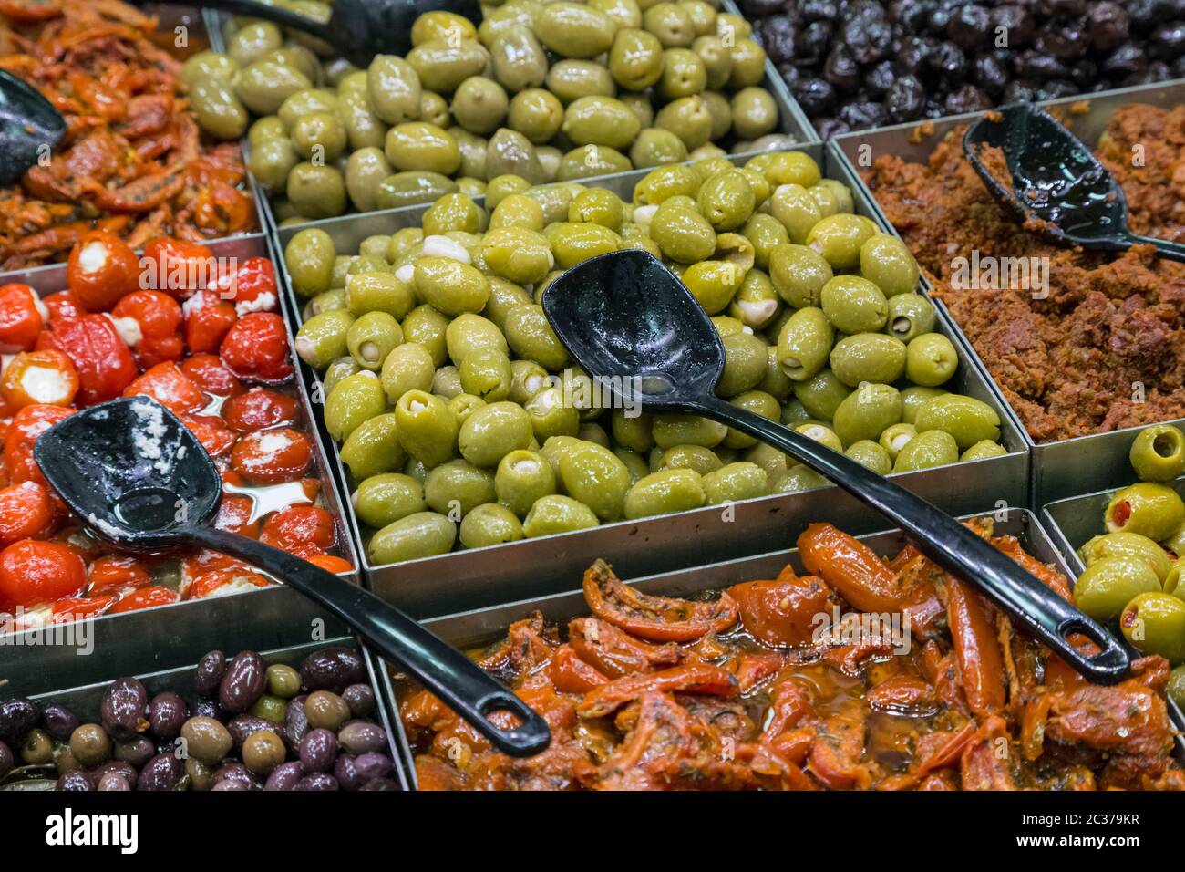 Olives and peppers on sale at a self service stall in a SuperValu store in Clonakilty, West Cork, County Cork, Republic of Ireland. Stock Photo