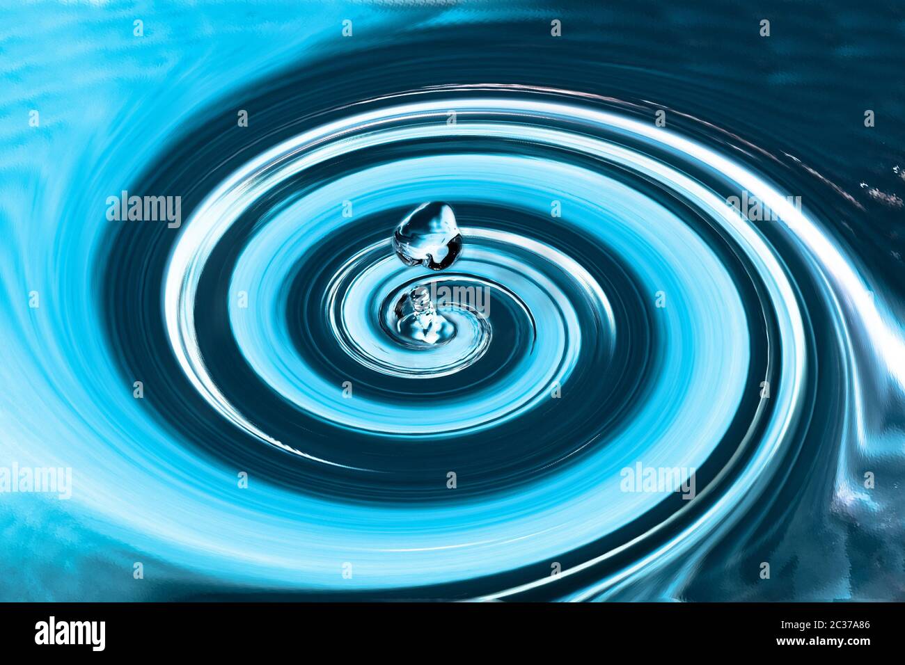 Abstract circular movement of water with a drop in the middle. A splash of water, moving water in a spiral. Stock Photo