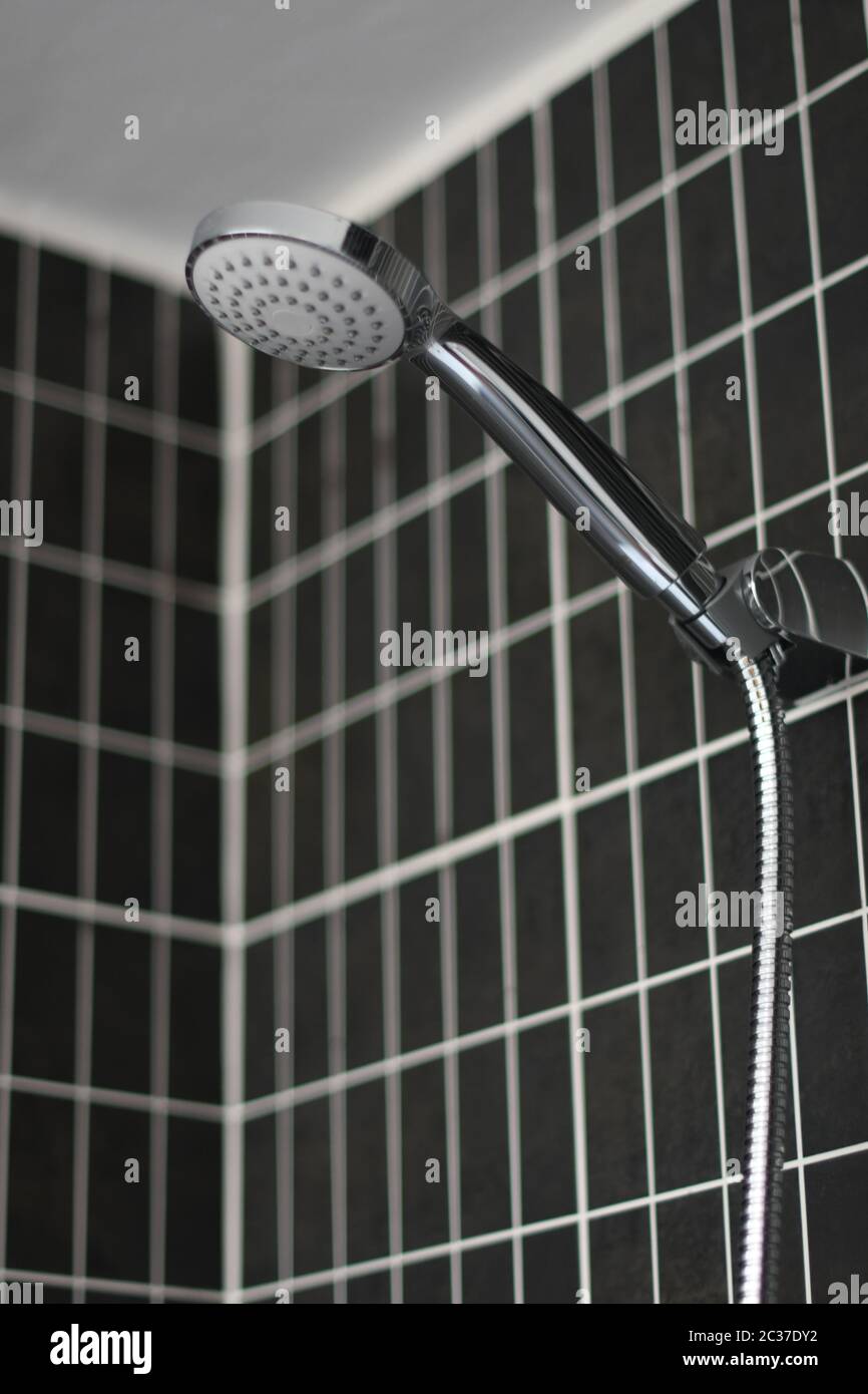 A showerhead close up in a dark wall Stock Photo