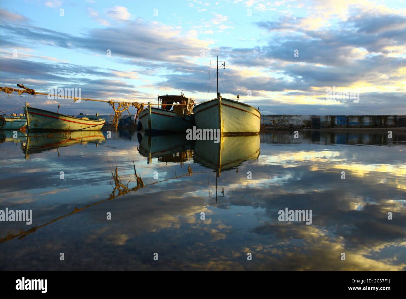 Reflection of boats in a small harbour Stock Photo - Alamy