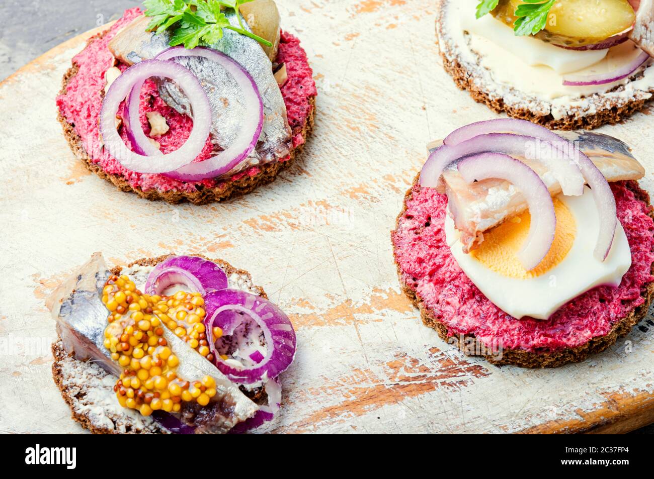 Small sandwiches or bruschettas with salted herring and beetroot.Open sandwich with salted herring Stock Photo
