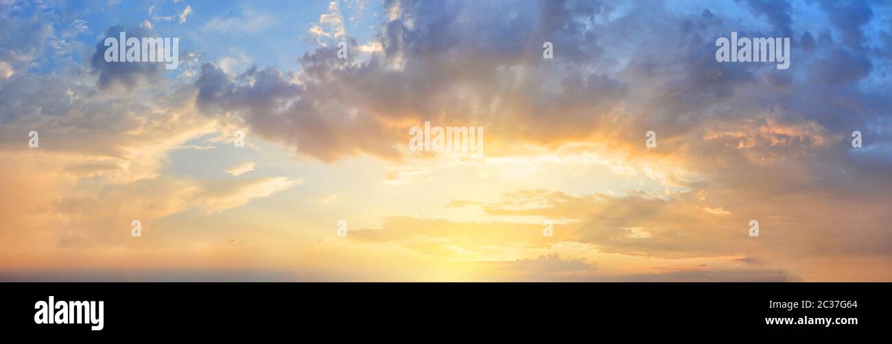 Panorama of orange sunset sky with the bright sun Stock Photo - Alamy