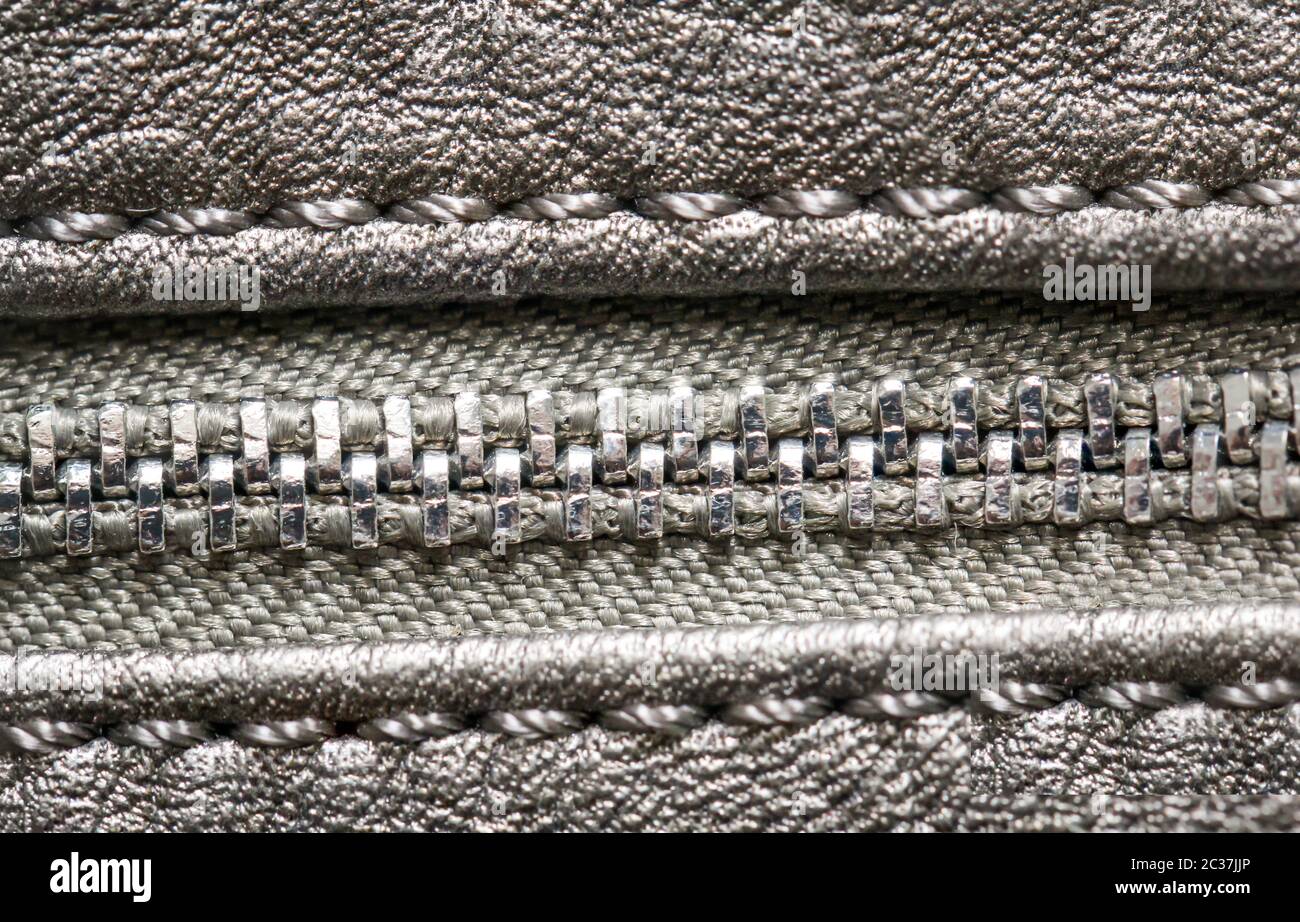 Close up of a zipper on a piece of leather Stock Photo