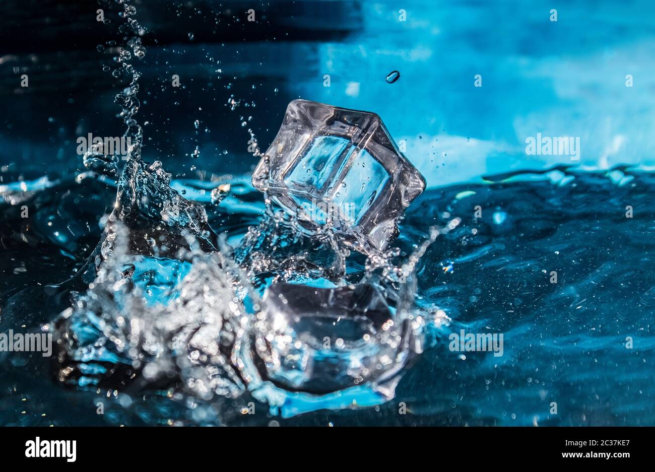 https://c8.alamy.com/comp/2C37KE7/ice-cubes-falling-into-the-blue-water-splash-of-ice-water-water-splashes-from-falling-ice-cubes-2C37KE7.jpg