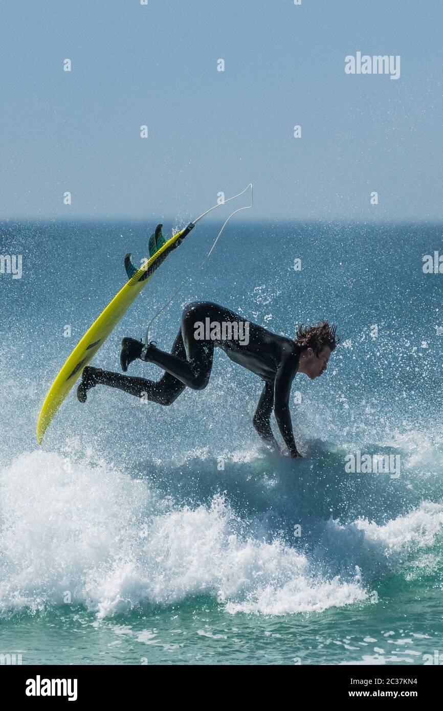 Spectacular action as a surfer wipes out at Fistral in Newquay in Cornwall. Stock Photo