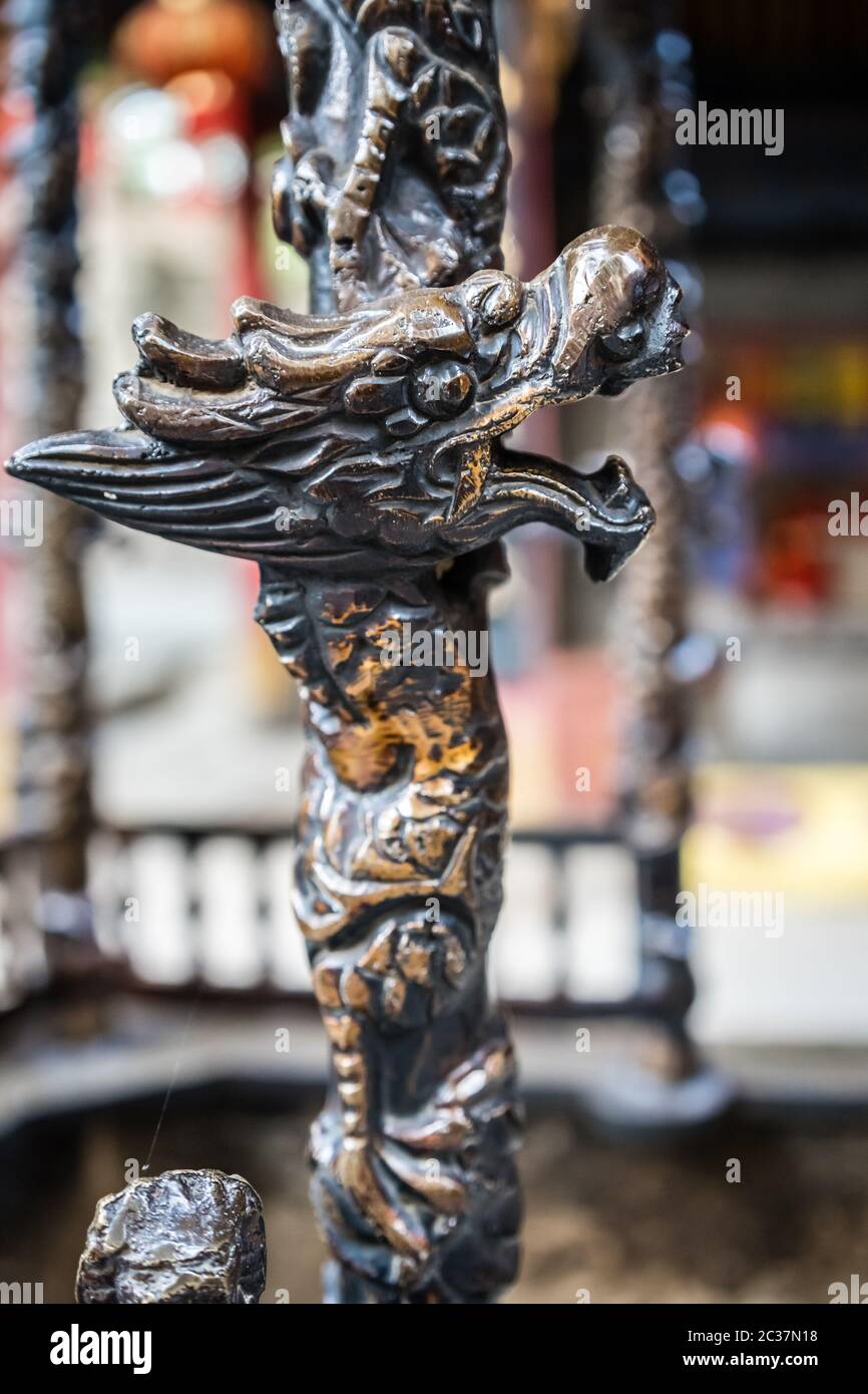 Close up of a dragon head sculpture decoration on a wooden stick, Buddhist Temple wall in Huashan town, Shaanxi Province, China Stock Photo