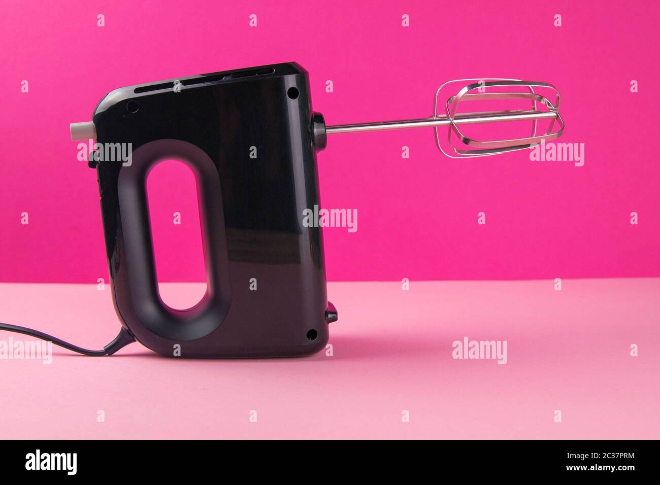 https://c8.alamy.com/comp/2C37PRM/kitchen-electric-hand-mixer-for-mixing-whip-or-eggs-on-pink-table-near-a-pink-background-close-up-2C37PRM.jpg