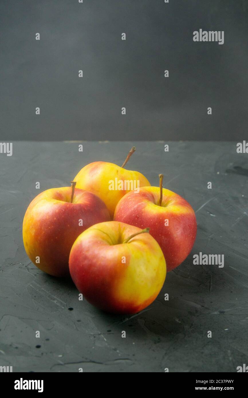 Apples on black stone table background. Front views Stock Photo
