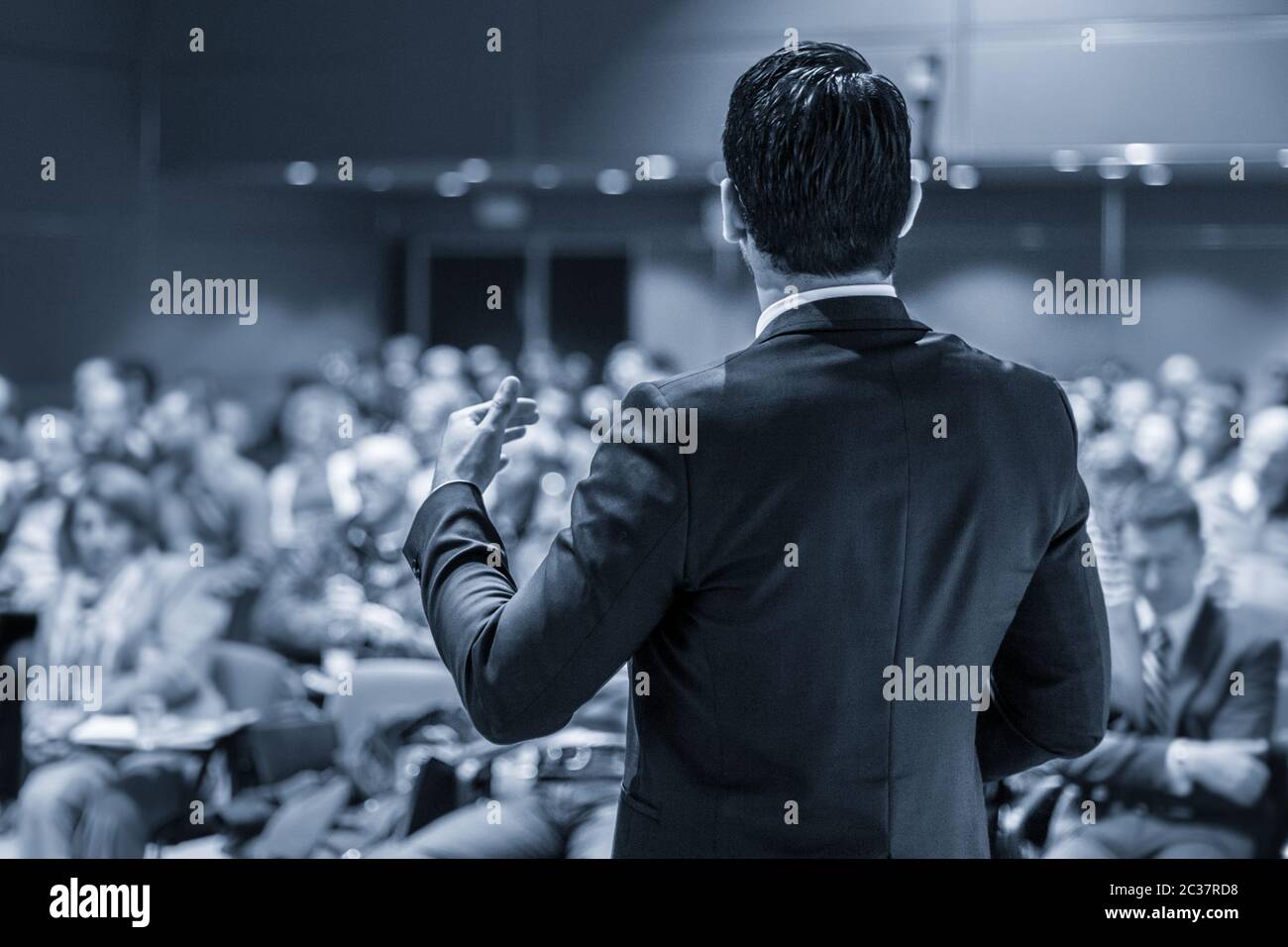 Speaker at Business Conference with Public Presentations. Audience at the conference hall. Entrepreneurship club. Rear view. Panoramic composition. Bl Stock Photo