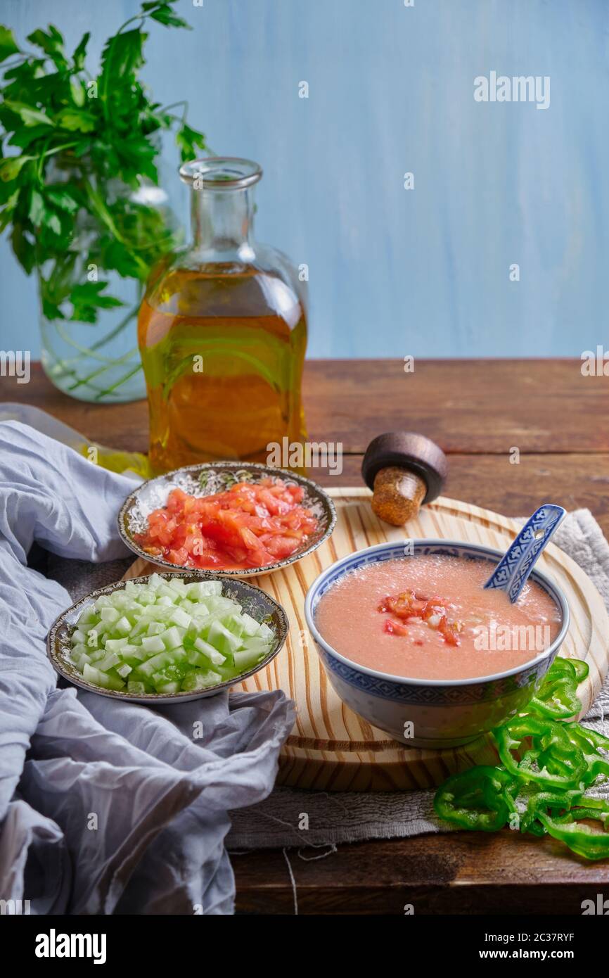 Summer soup with a creamy texture that is served cold, made from a large quantity of ripe tomatoes, fresh seasonal vegetables, it can be served alone Stock Photo