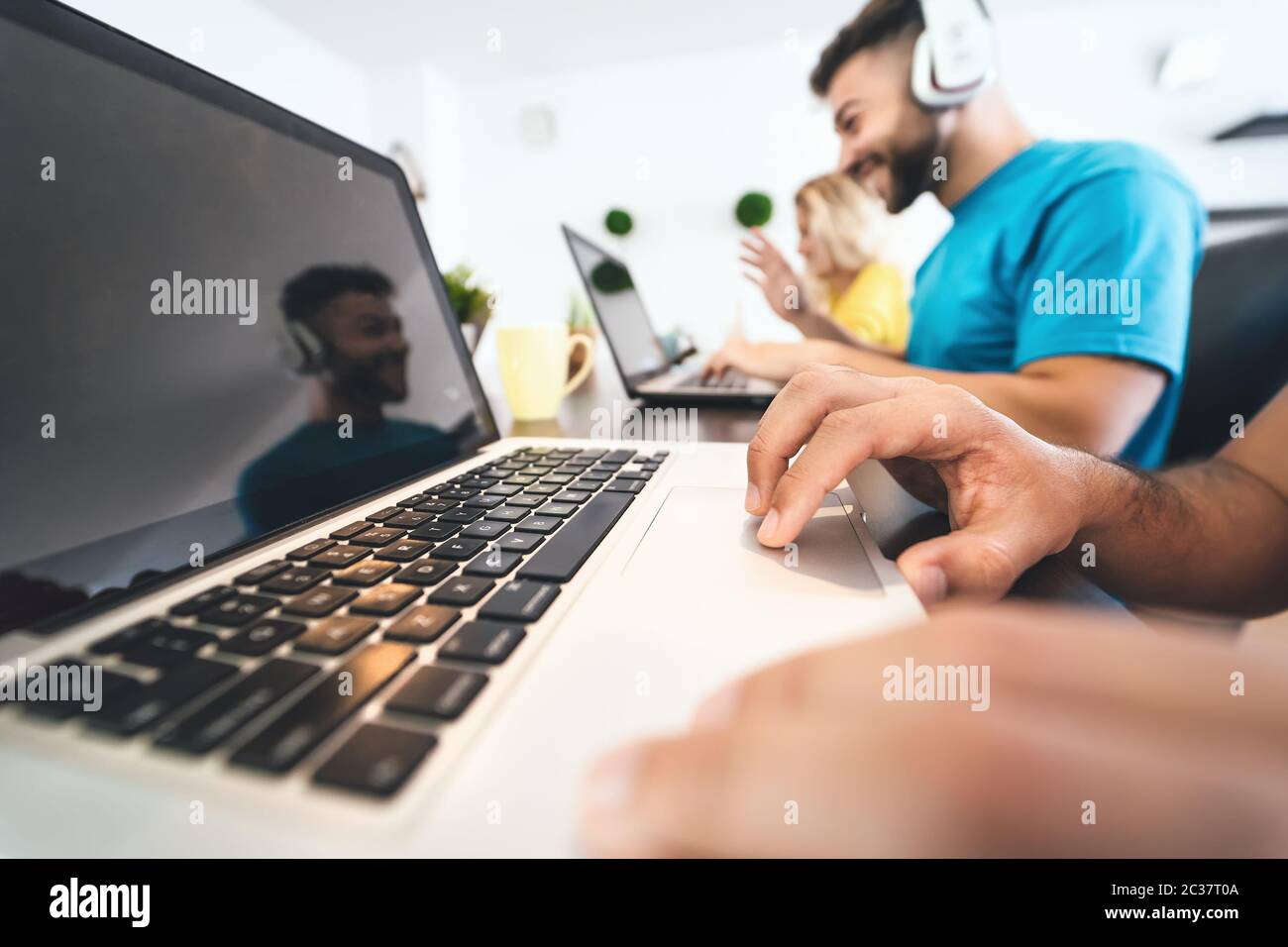 Young friends working together inside co-working space - Millennial people doing startup strategy in modern office Stock Photo
