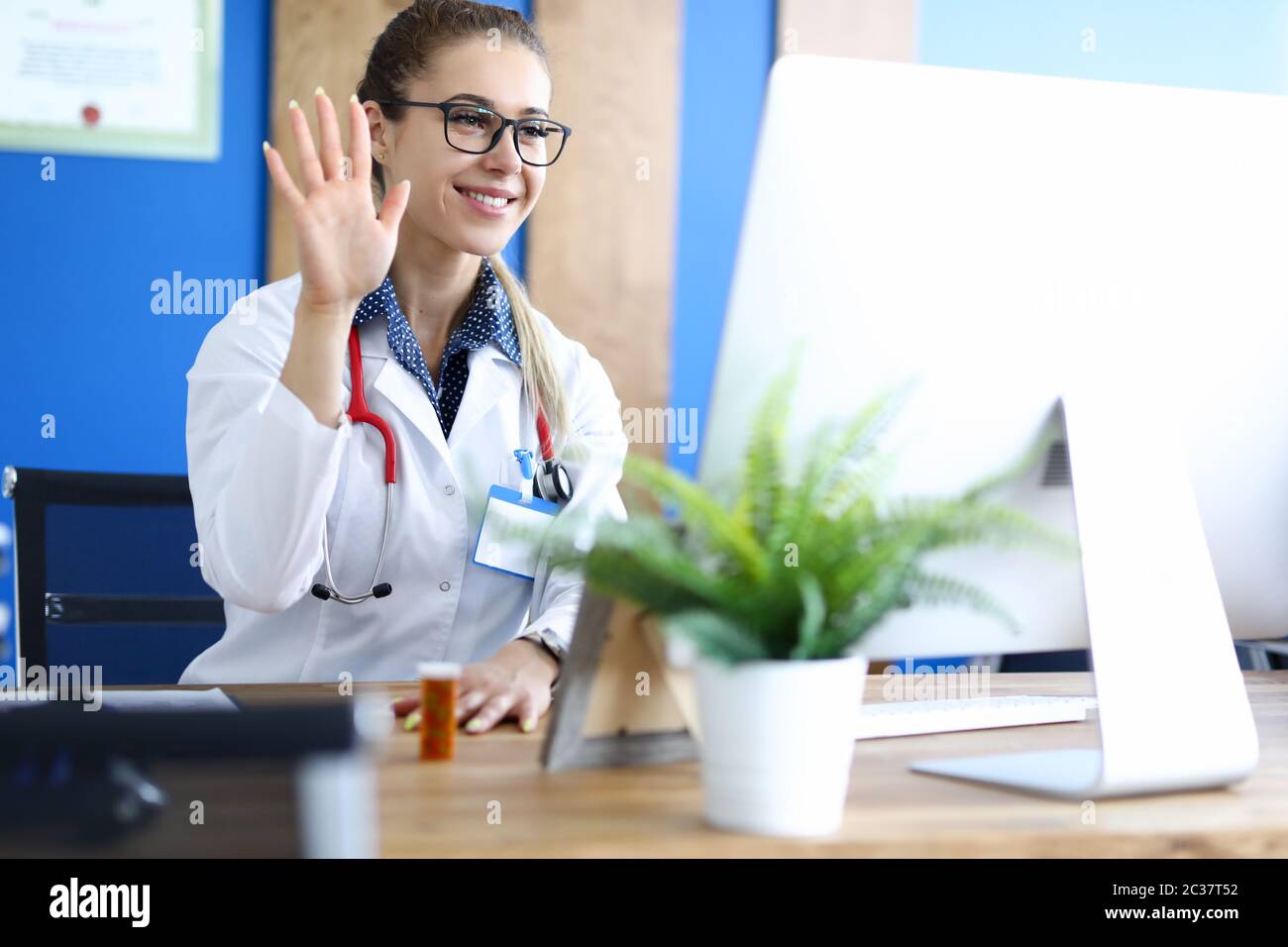 Young caucasian female doctor talking with patient against hospital ...