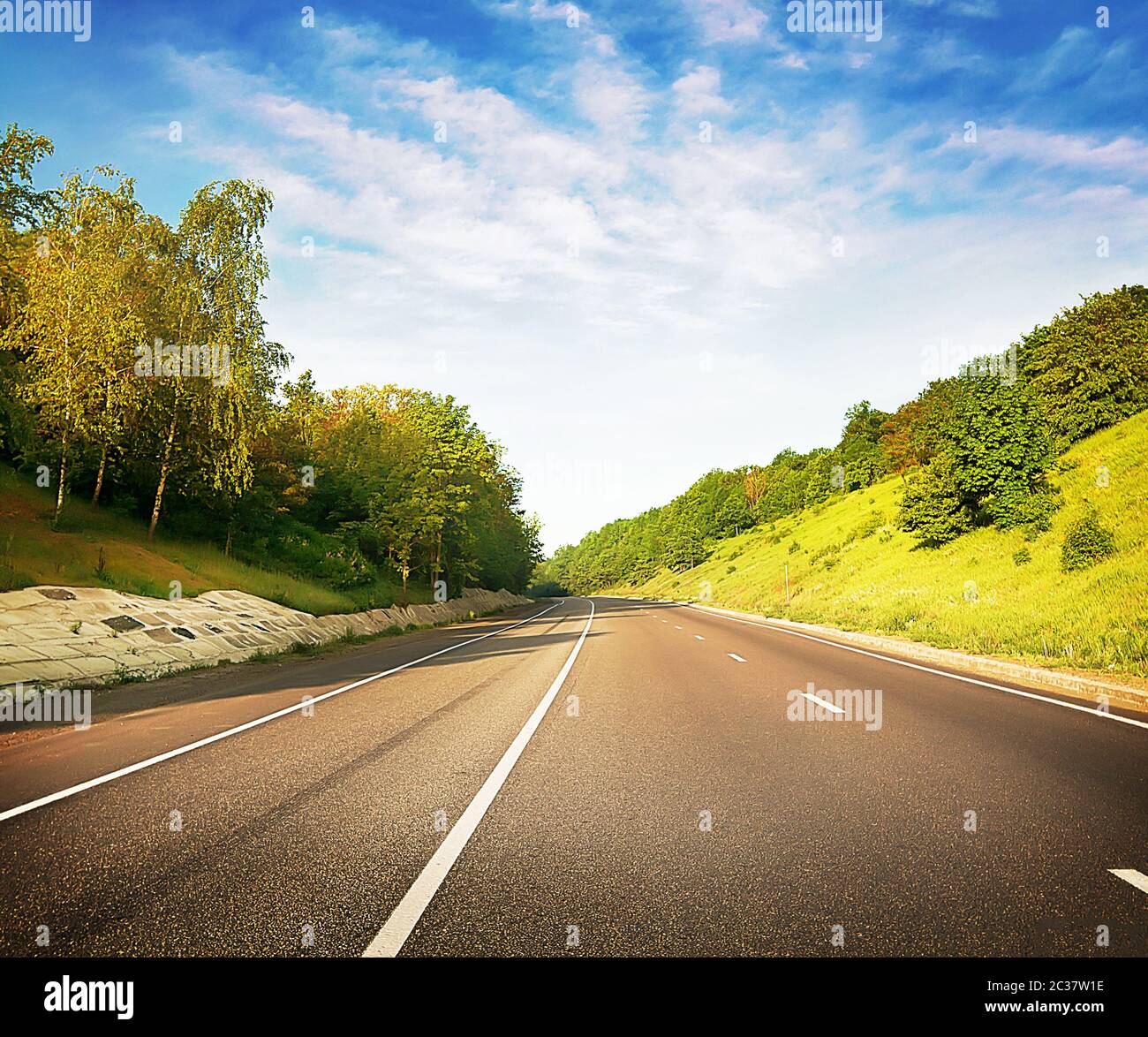 Asphalt road stretches into the distance in the hills Stock Photo - Alamy