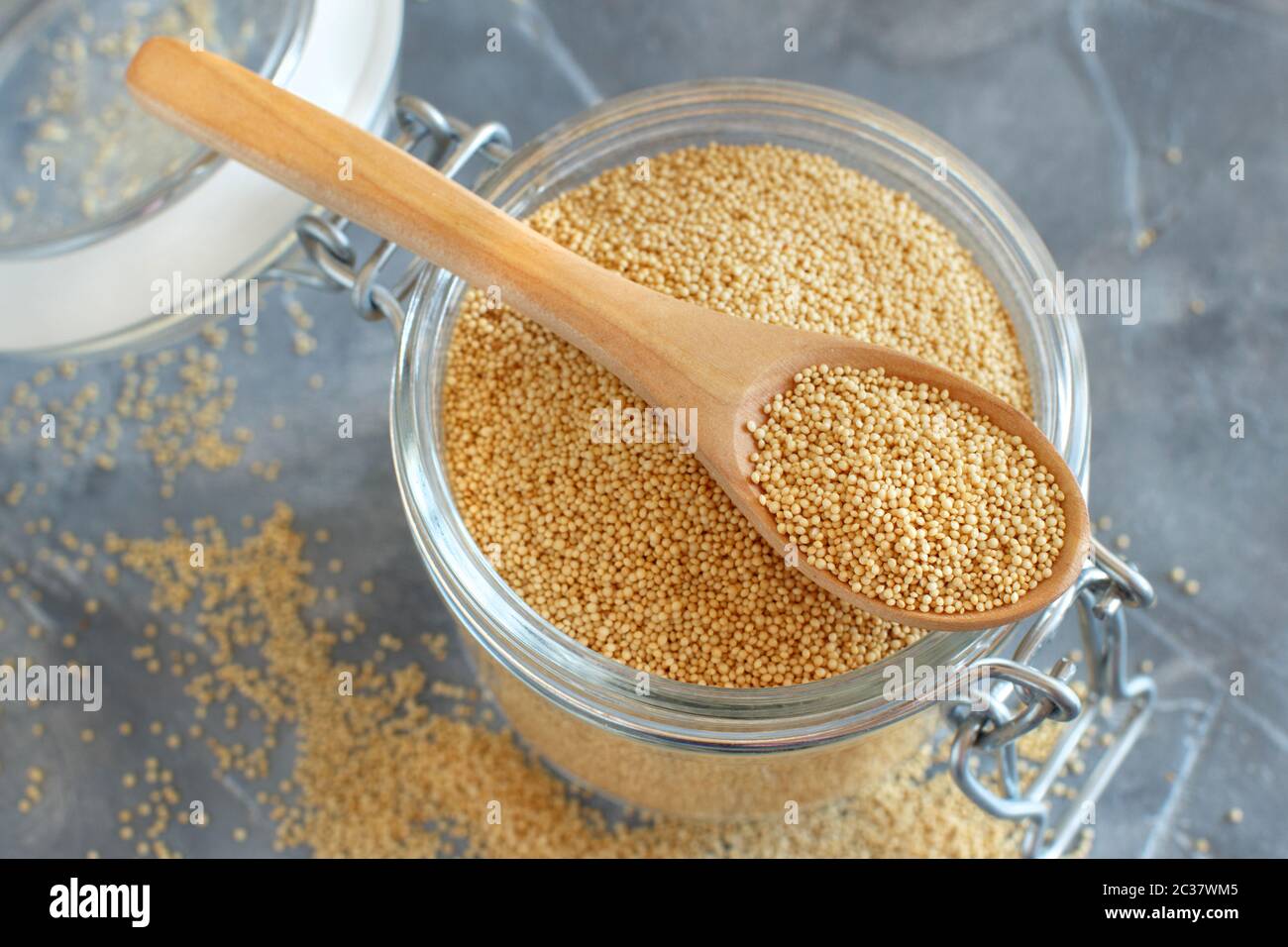 Glass jar of raw Amaranth Grain with a spoon close up Stock Photo