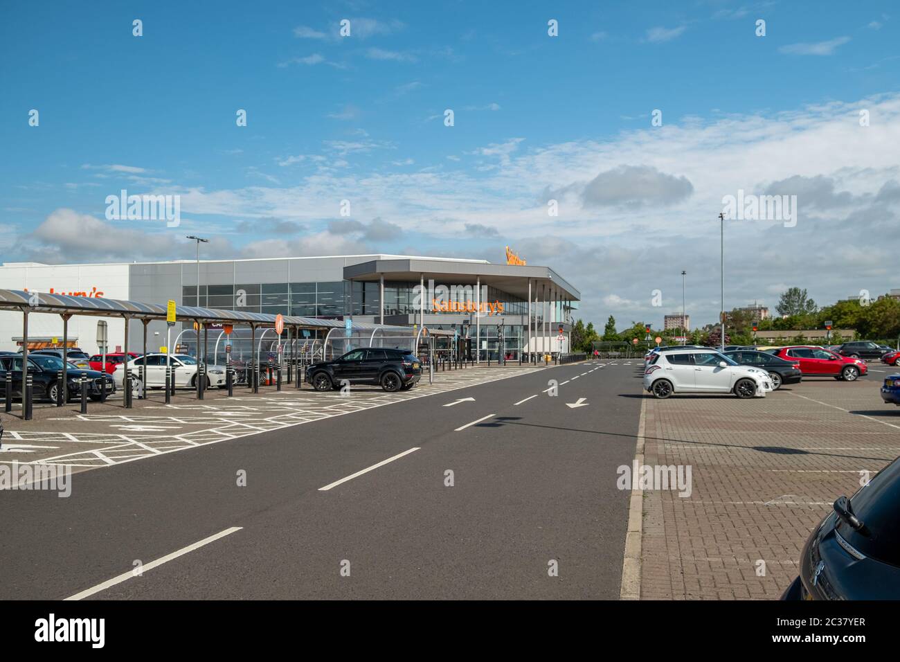Irvine, Scotland, UK - June 15, 2020: Sainsbury’s Branded supermarkets still quiet with half empty carparks in Irvine during covid-19 lockdown. Stock Photo