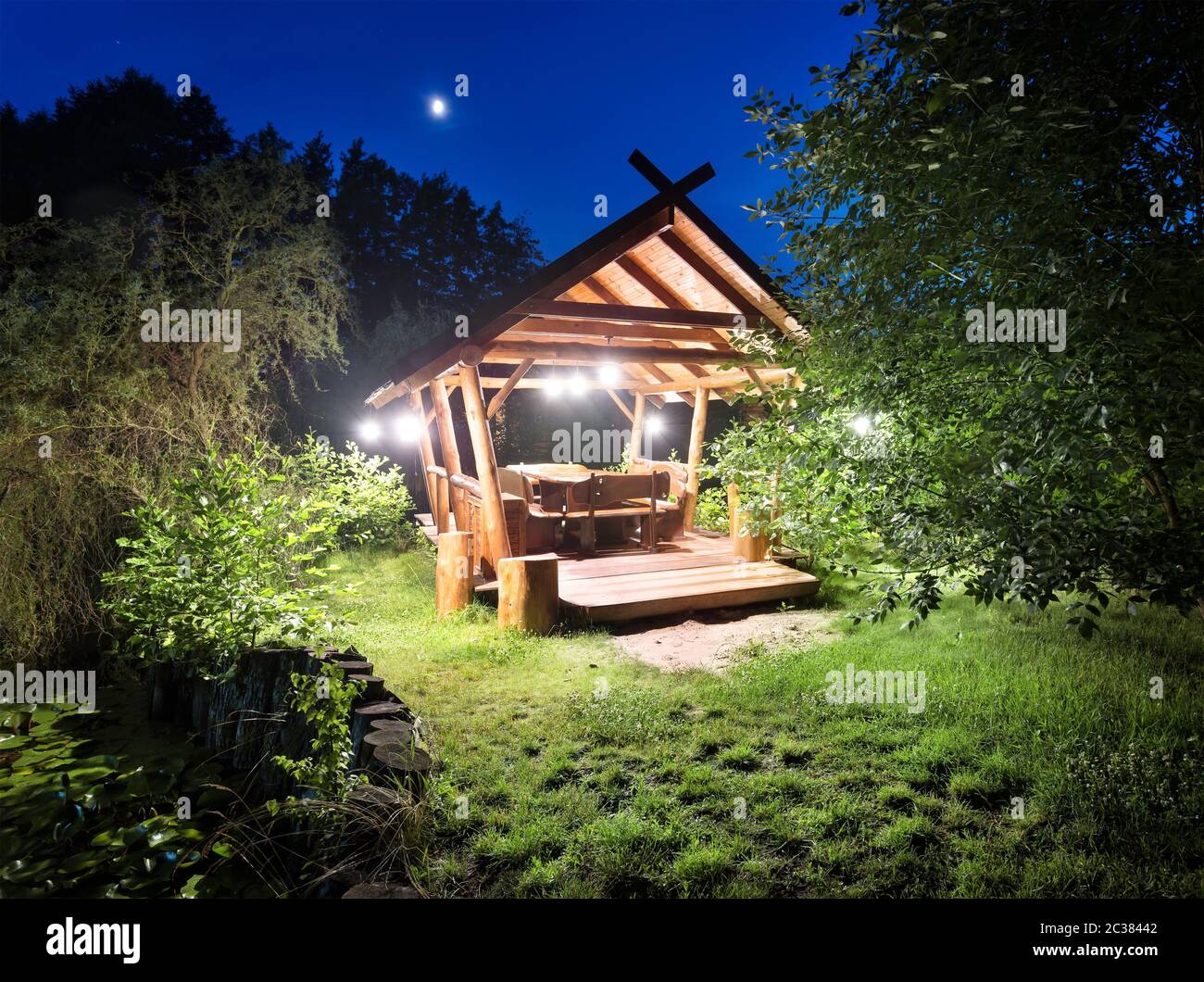 Fairy gazebo in woods lit lanterns at night Stock Photo Alamy
