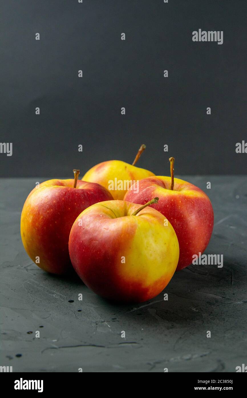 Apples on black stone table background. Front views Stock Photo