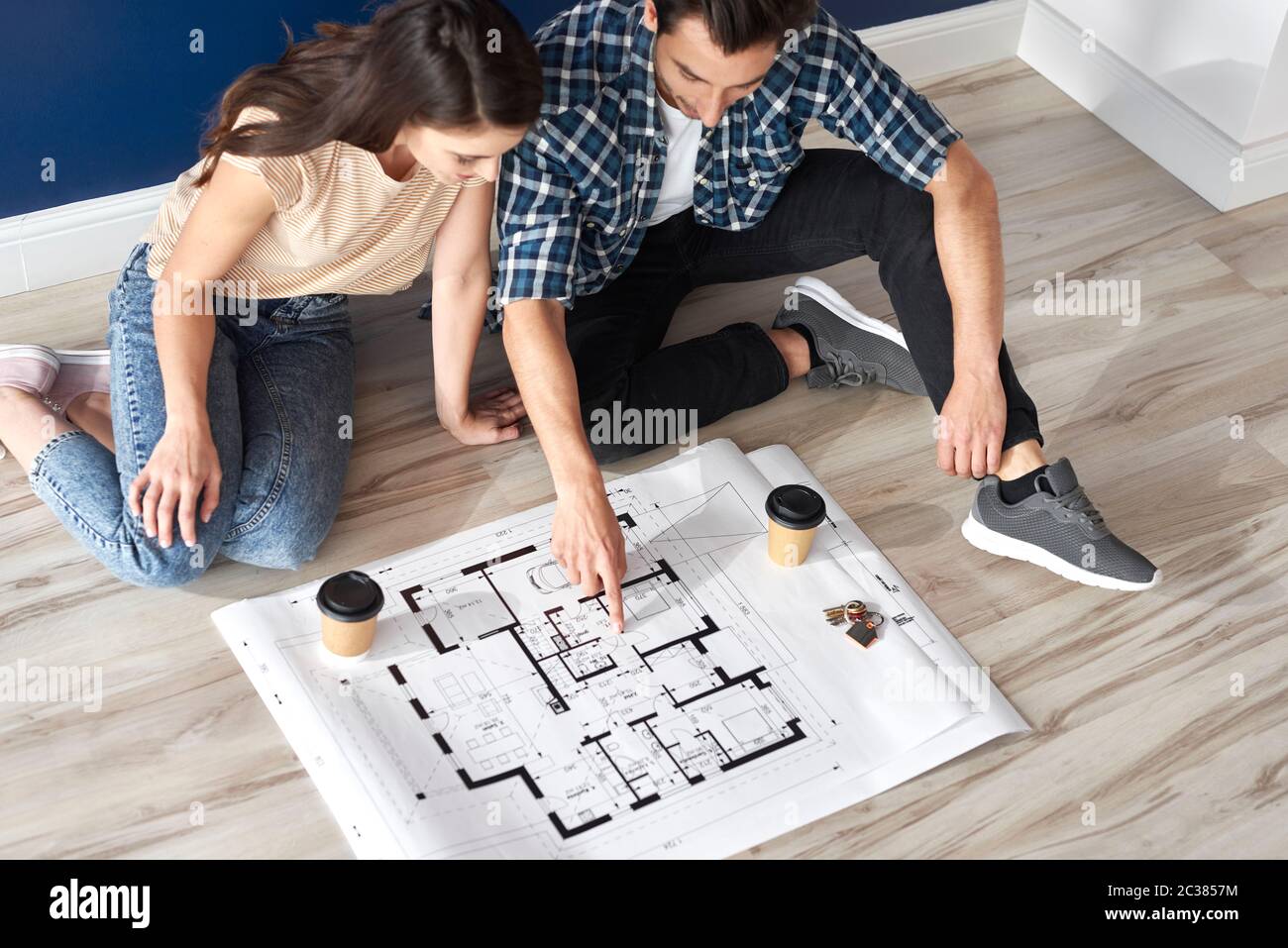 Couple looking at blueprint in new house Stock Photo