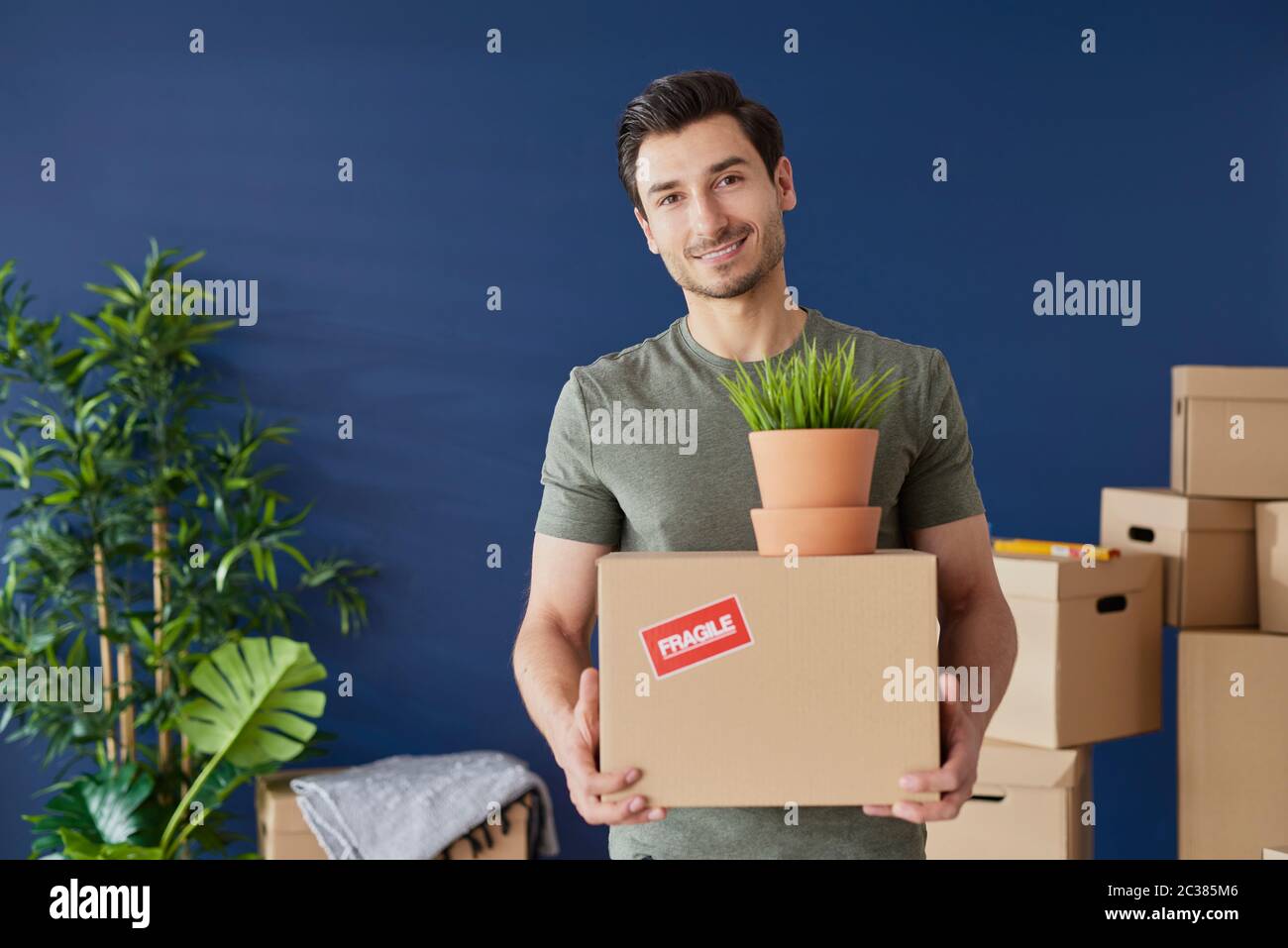 Portrait of young man with a cardboard box Stock Photo