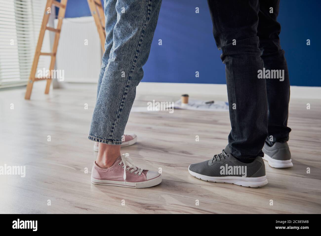 Legs of couple standing in new apartment Stock Photo