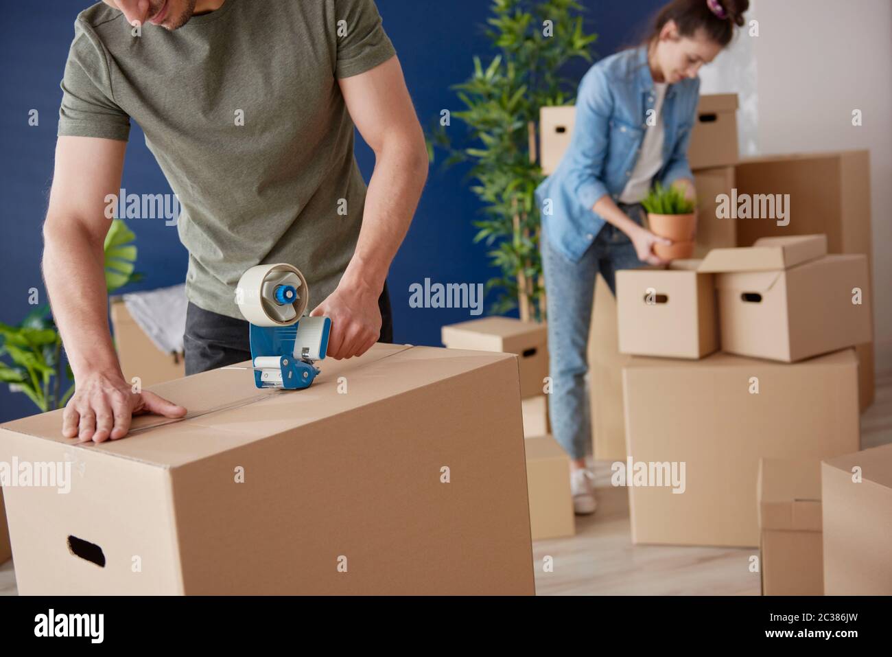 Couple packing cardboard boxes while moving house Stock Photo Alamy