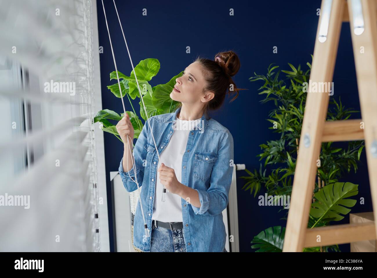 Woman next to the window during house renovation Stock Photo