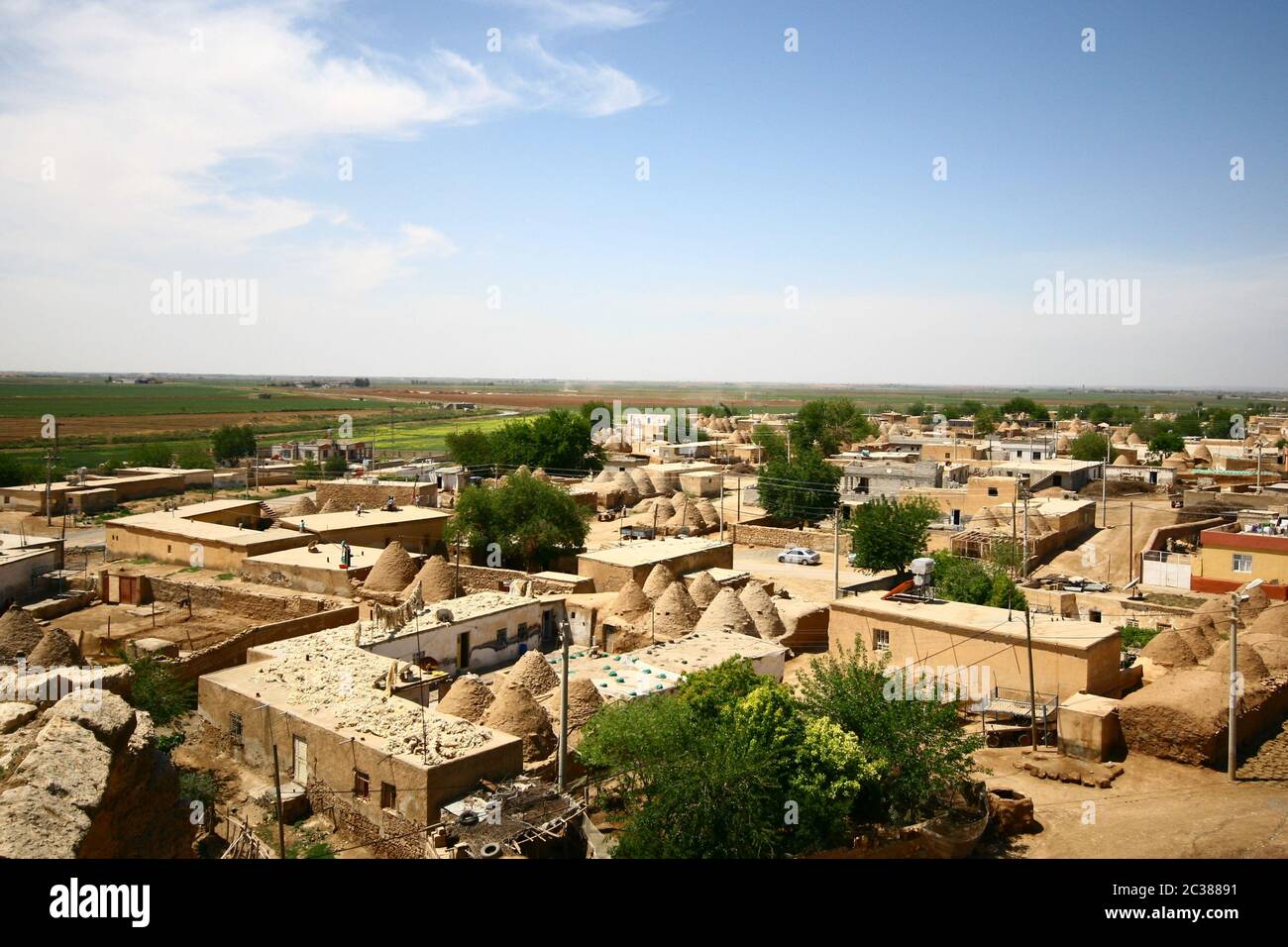 Traditional beehive mud brick desert houses,Harran, Turkey. Mud brick buildings topped with domed roofs and constructed from mud and salvaged brick. Stock Photo