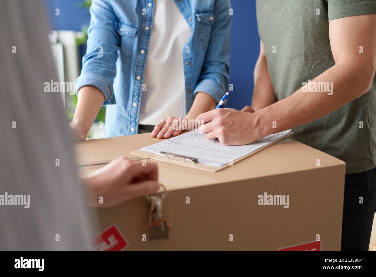 Couple signing a house purchase agreement Stock Photo