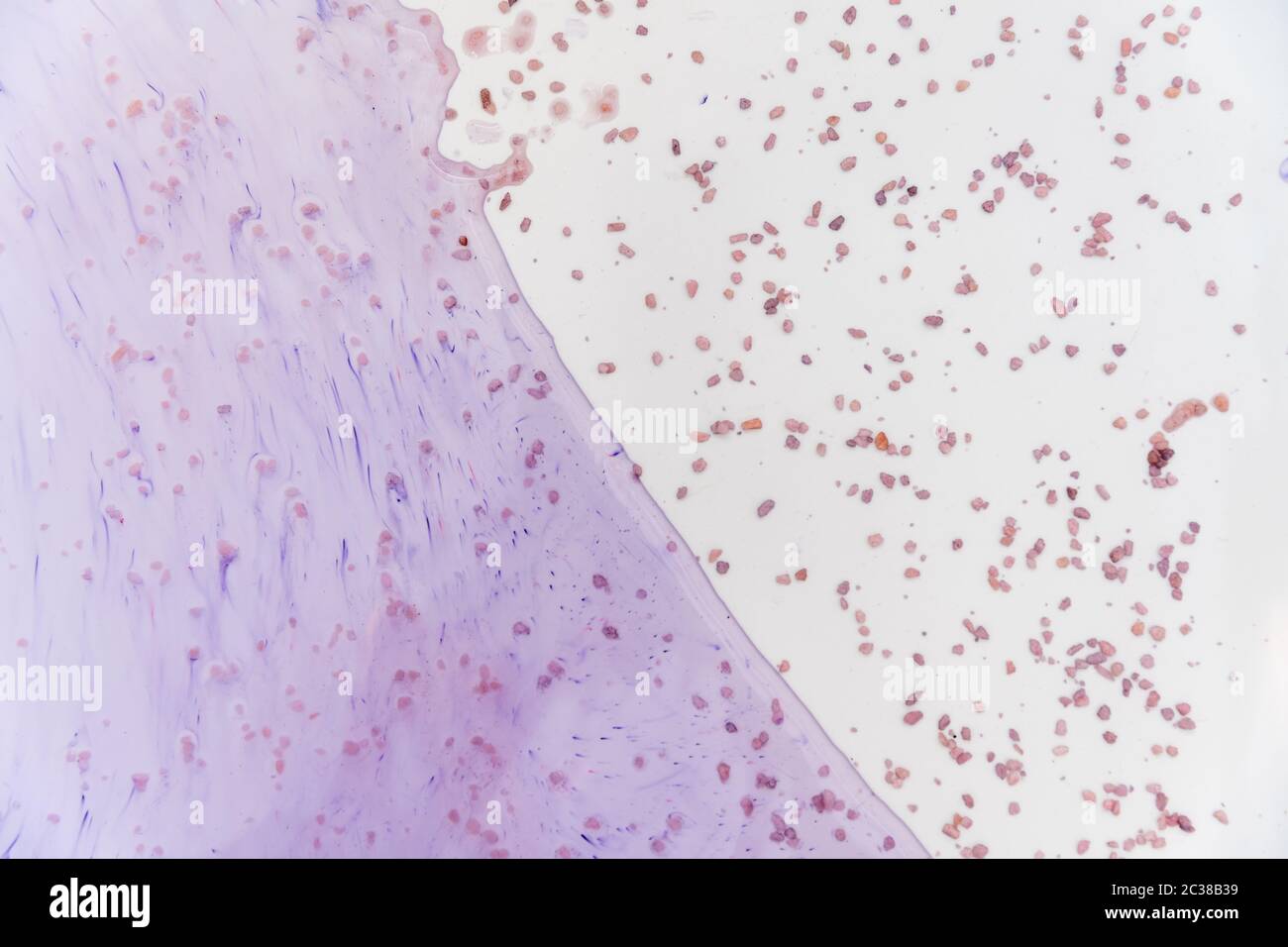 Blue spots from the dye in the white tub dissolves in water Stock Photo