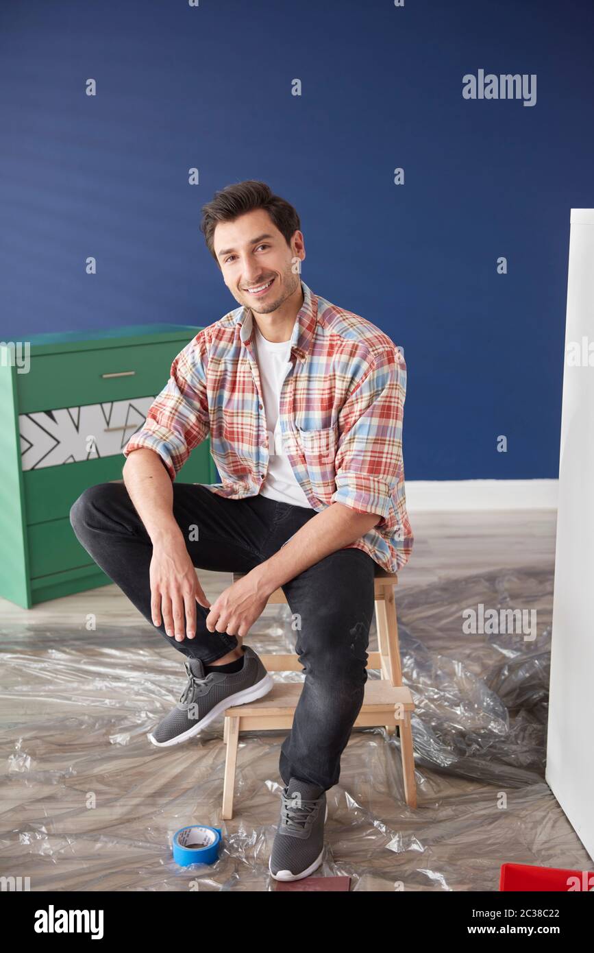 Portrait of man repainting a house Stock Photo