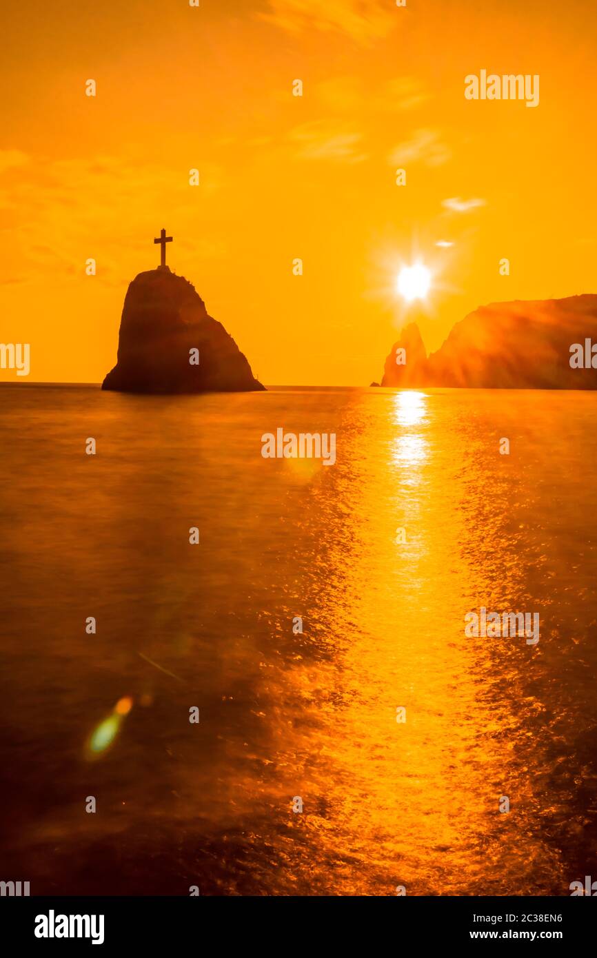 A red burning sunset with the silhouett of cape Fiolent and cliff over ...